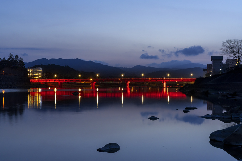 赤く点灯した水の手橋を遠くから撮影した写真